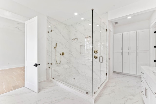 bathroom with hardwood / wood-style flooring, vanity, and an enclosed shower