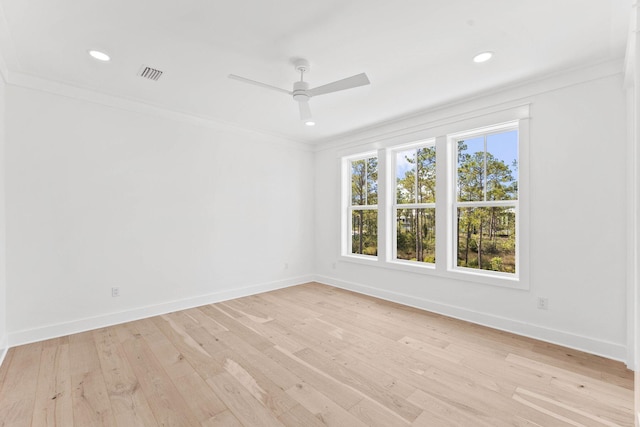 unfurnished room featuring a healthy amount of sunlight, crown molding, ceiling fan, and light hardwood / wood-style floors