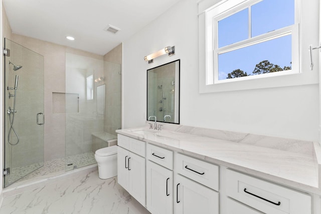 bathroom featuring tile patterned flooring, a shower with door, toilet, and vanity