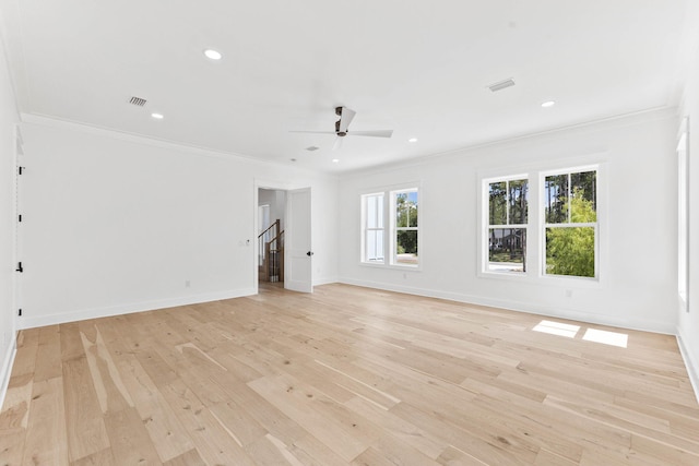 unfurnished living room featuring a healthy amount of sunlight, crown molding, light wood-type flooring, and ceiling fan