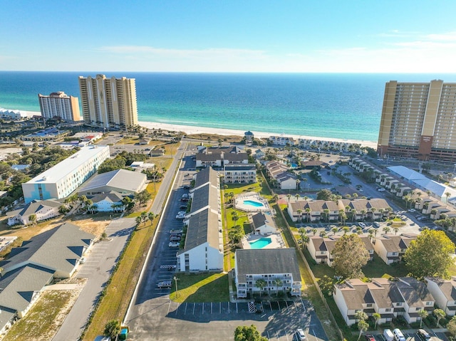 bird's eye view with a water view and a beach view