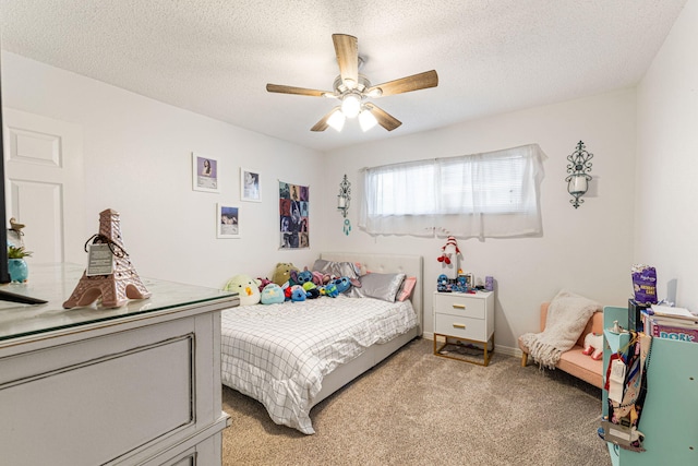 bedroom with ceiling fan, a textured ceiling, and light colored carpet