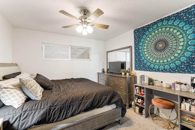 bedroom with carpet, ceiling fan, and a textured ceiling