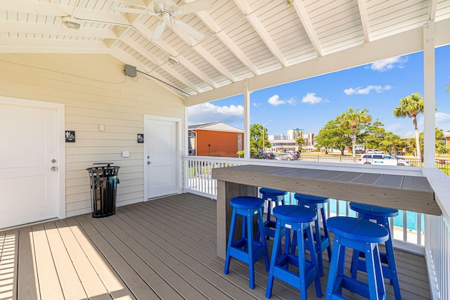 wooden deck with a shed and ceiling fan