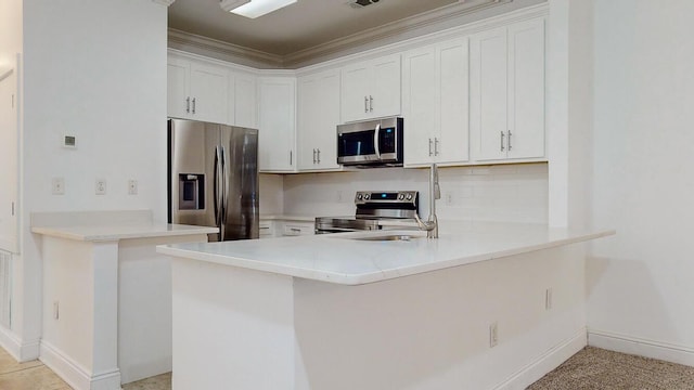 kitchen featuring kitchen peninsula, white cabinetry, and appliances with stainless steel finishes