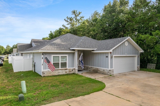 ranch-style house featuring a garage and a front lawn