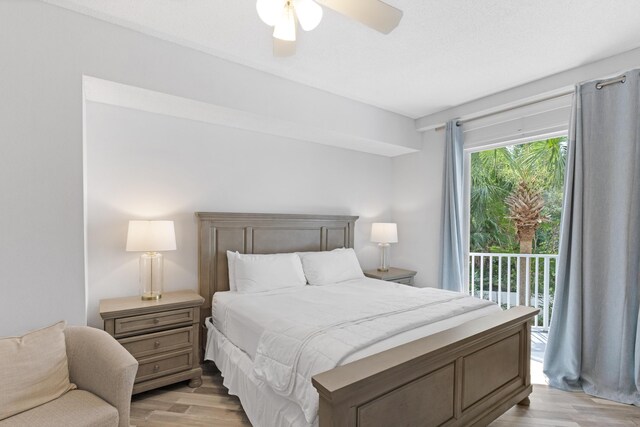 bedroom featuring access to exterior, light hardwood / wood-style flooring, and ceiling fan