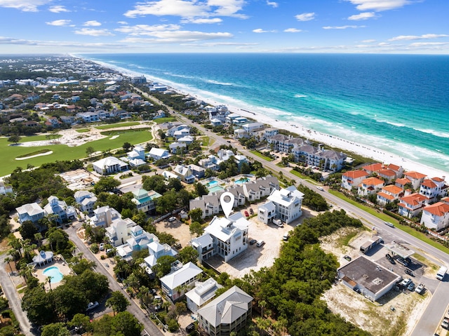 bird's eye view with a water view and a beach view