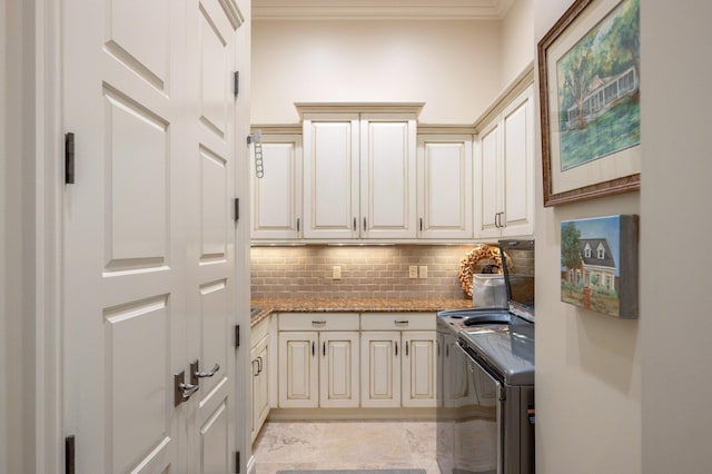 kitchen featuring washer and clothes dryer, light stone counters, and backsplash