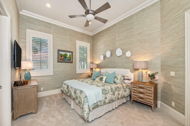 carpeted bedroom featuring ceiling fan and crown molding