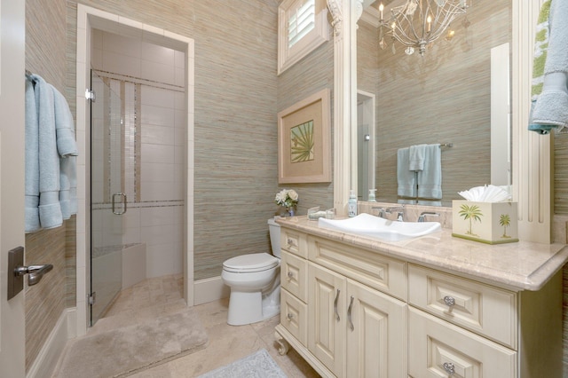 bathroom with vanity, tile patterned floors, toilet, walk in shower, and a notable chandelier