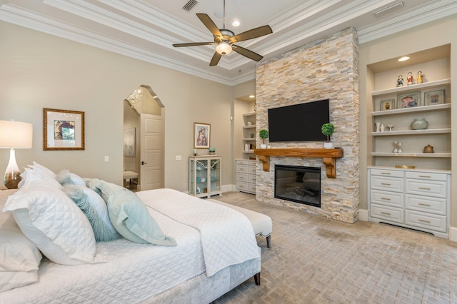 bedroom with a fireplace, ceiling fan, and ornamental molding