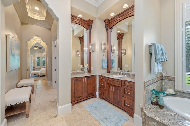 bathroom featuring a tub, ceiling fan, vanity, and ornamental molding