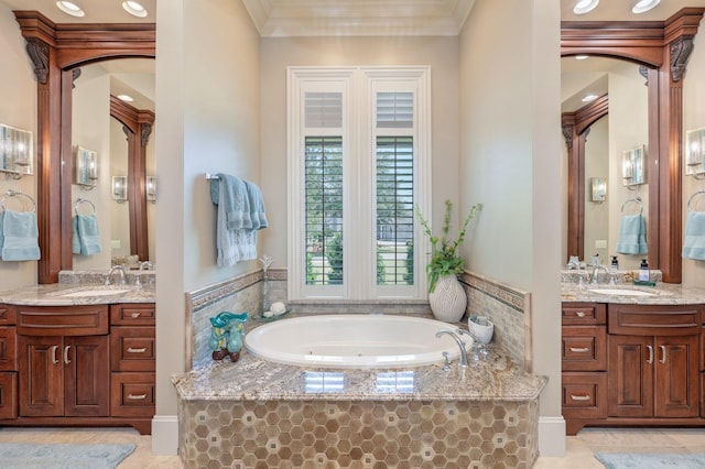 bathroom with tile patterned floors, vanity, and a relaxing tiled tub