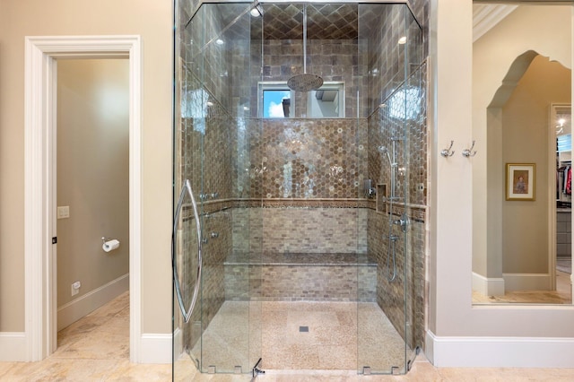 bathroom featuring walk in shower and ornamental molding