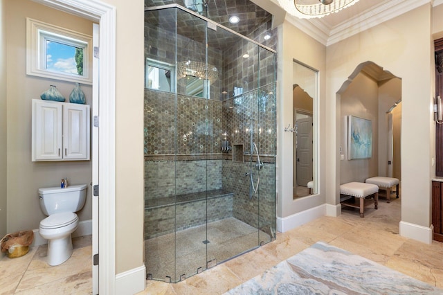 bathroom with tile patterned floors, a shower with shower door, toilet, and ornamental molding