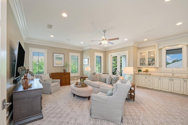 living room featuring crown molding and ceiling fan