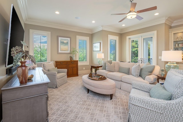 living room featuring a wealth of natural light, crown molding, and ceiling fan