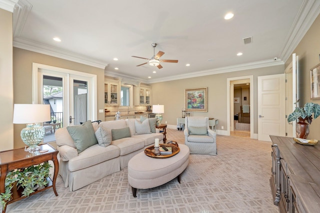 carpeted living room featuring ceiling fan and crown molding