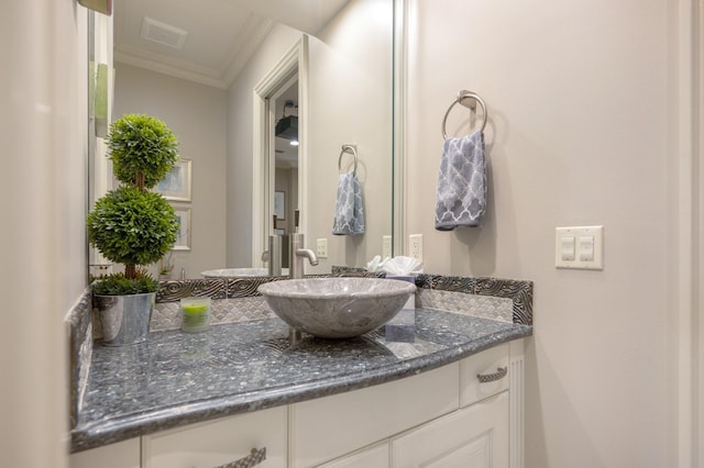 bathroom featuring vanity and ornamental molding