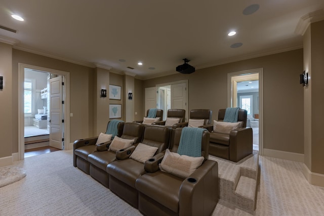 cinema room with light colored carpet and ornamental molding