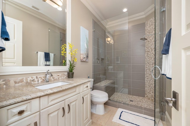 bathroom with vanity, a shower with door, crown molding, tile patterned flooring, and toilet