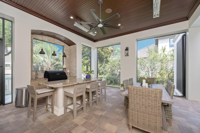 view of patio with a grill, ceiling fan, and sink