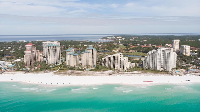 drone / aerial view with a beach view and a water view