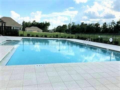 community pool featuring fence