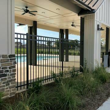 view of gate featuring ceiling fan, fence, and a community pool