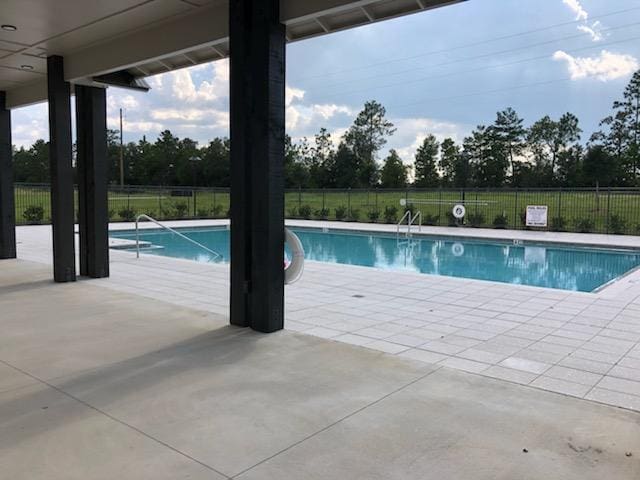 pool featuring a patio area and fence