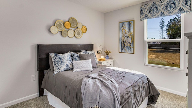 bedroom featuring baseboards and carpet flooring