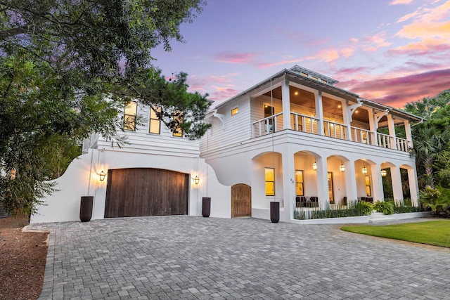 view of front of home with a balcony and a garage