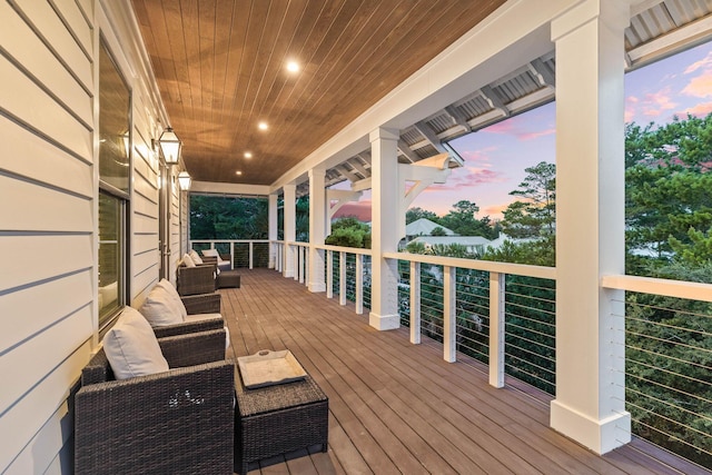 deck at dusk with an outdoor hangout area