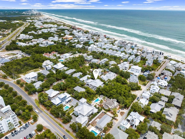 drone / aerial view featuring a water view and a view of the beach