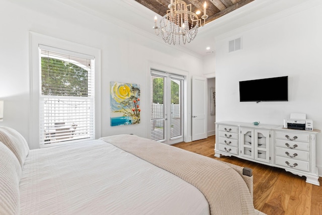 bedroom with crown molding, beamed ceiling, light hardwood / wood-style flooring, and access to outside