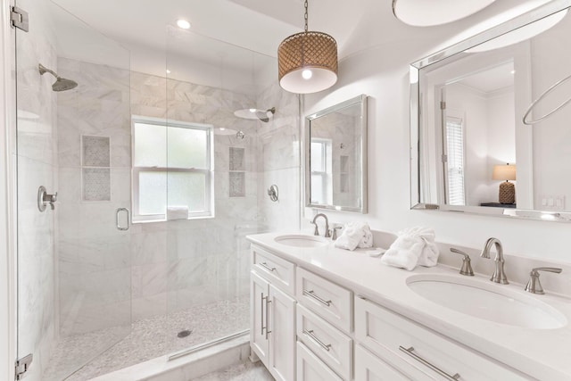 bathroom featuring a shower with door and vanity