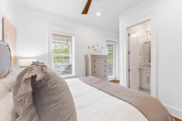 bedroom with ensuite bath, ornamental molding, and ceiling fan