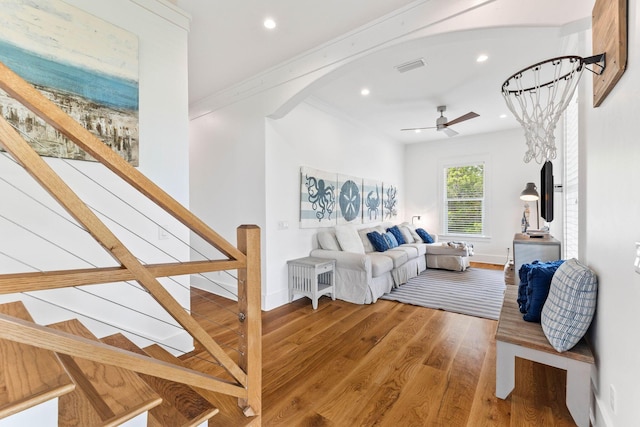 living room featuring hardwood / wood-style flooring, ceiling fan, and ornamental molding