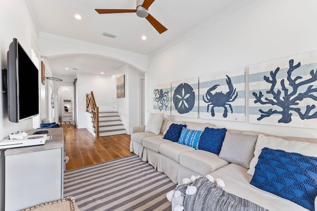 living room with crown molding, ceiling fan, and hardwood / wood-style flooring