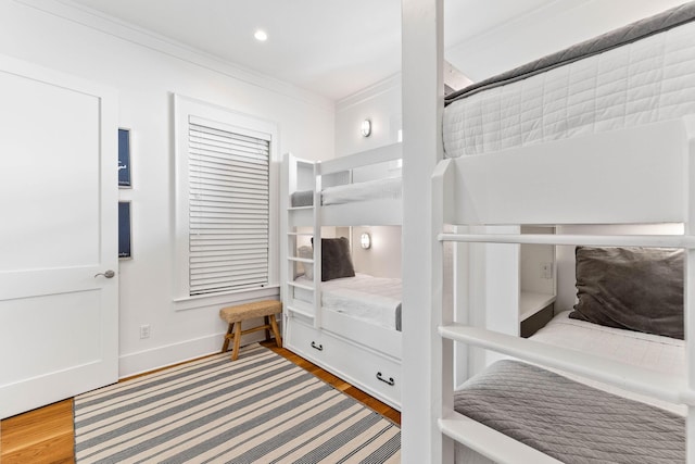 bedroom featuring ornamental molding and wood-type flooring