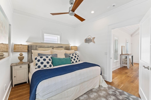 bedroom featuring wood-type flooring, ornamental molding, and ceiling fan