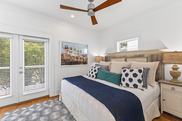 bedroom with wood-type flooring, access to exterior, and multiple windows