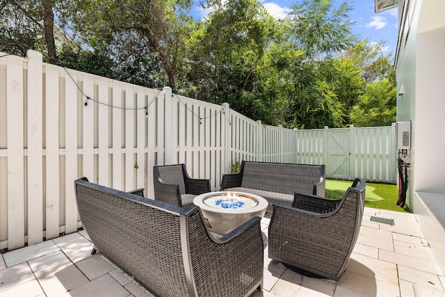 view of patio / terrace featuring an outdoor living space with a fire pit