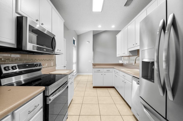 kitchen with white cabinets, appliances with stainless steel finishes, backsplash, and sink