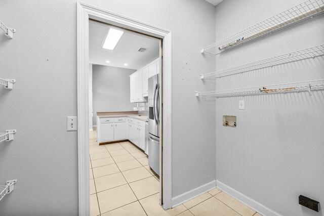 laundry room with hookup for a washing machine and light tile patterned flooring