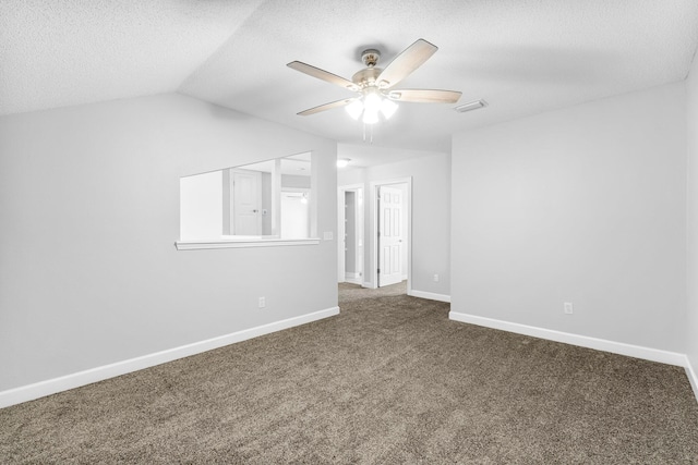 carpeted spare room with lofted ceiling, ceiling fan, and a textured ceiling