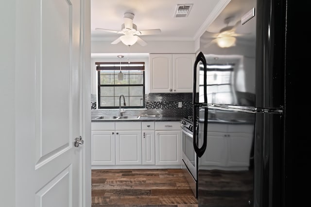 kitchen featuring white cabinets, sink, fridge, dark hardwood / wood-style flooring, and ornamental molding