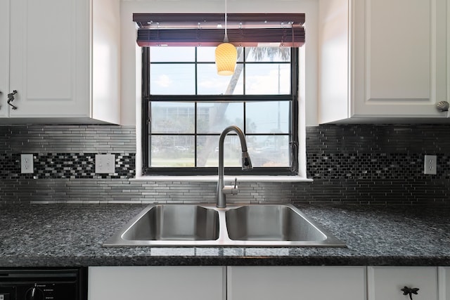 kitchen featuring sink, decorative backsplash, white cabinets, and plenty of natural light