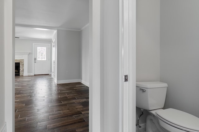 356 Billfish Ave Unit 8, Fort Walton Beach, FL 32548 - bathroom with hardwood / wood-style flooring, toilet, ornamental molding, baseboards, and a stone fireplace